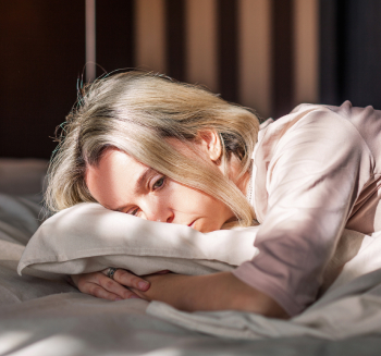 Worried woman in bed.